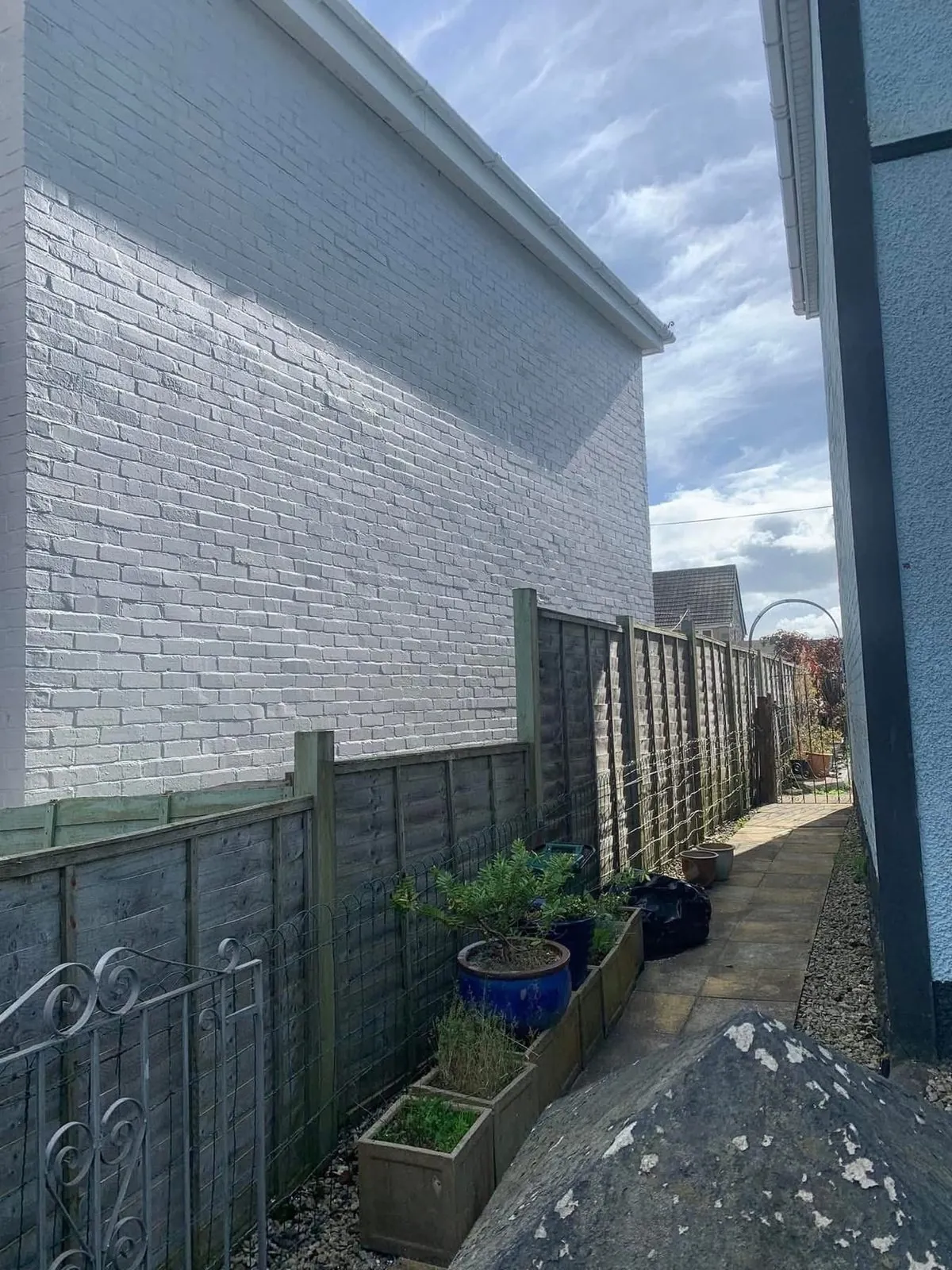 Freshly painted brick wall after preparation and masonry paint in Newton Abbot